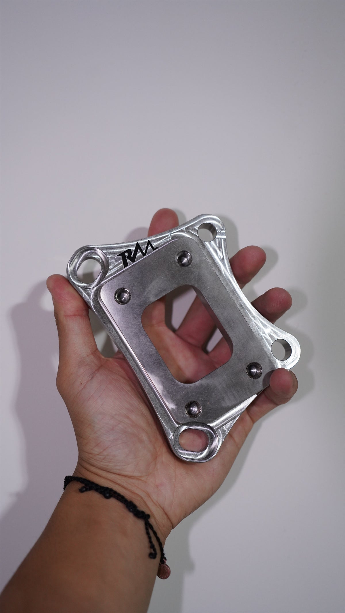 Revive Motorsports T25 turbo adapter, alternate front view with RM engraving