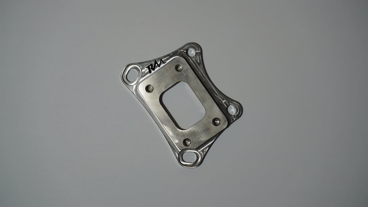 Revive Motorsports T25 turbo adapter, flat front view with RM engraving
