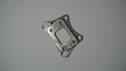 Revive Motorsports T25 turbo adapter, flat front view with RM engraving